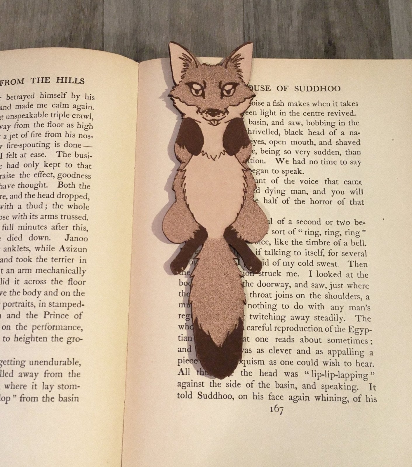 a fox bookmark resting on a book