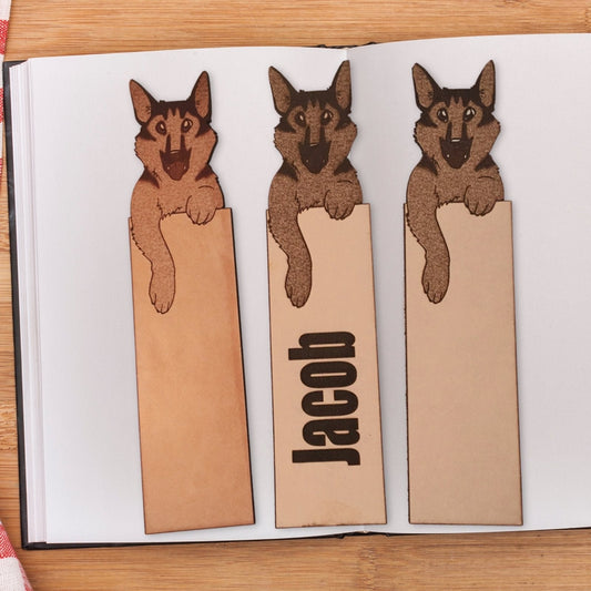 A photograph of three German Shepherd dog bookmarks. The left one is not personalized and the middle one is personalized.