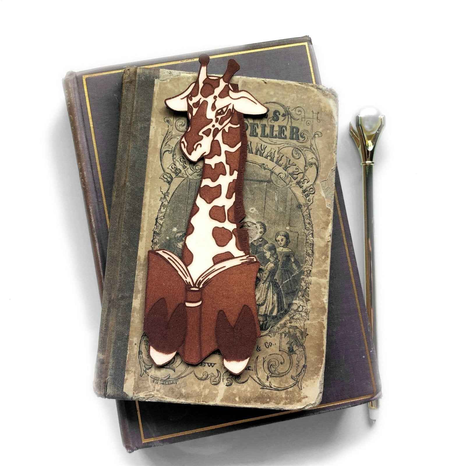 A leather bookmark shaped like a giraffee reading a book. Great Book lover gift. Giraffe Reading Leather Bookmark - Quirky Book-Lover Gift Bookmarks Raven King Crafts