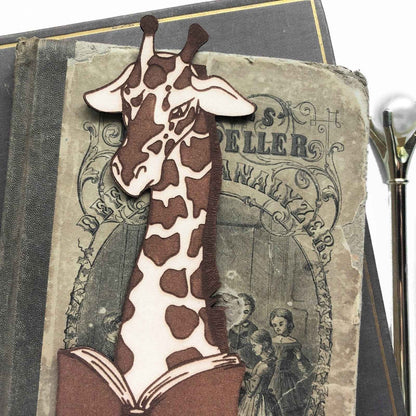 A leather bookmark shaped like a giraffee reading a book. Great Book lover gift. Giraffe Reading Leather Bookmark - Quirky Book-Lover Gift Bookmarks Raven King Crafts