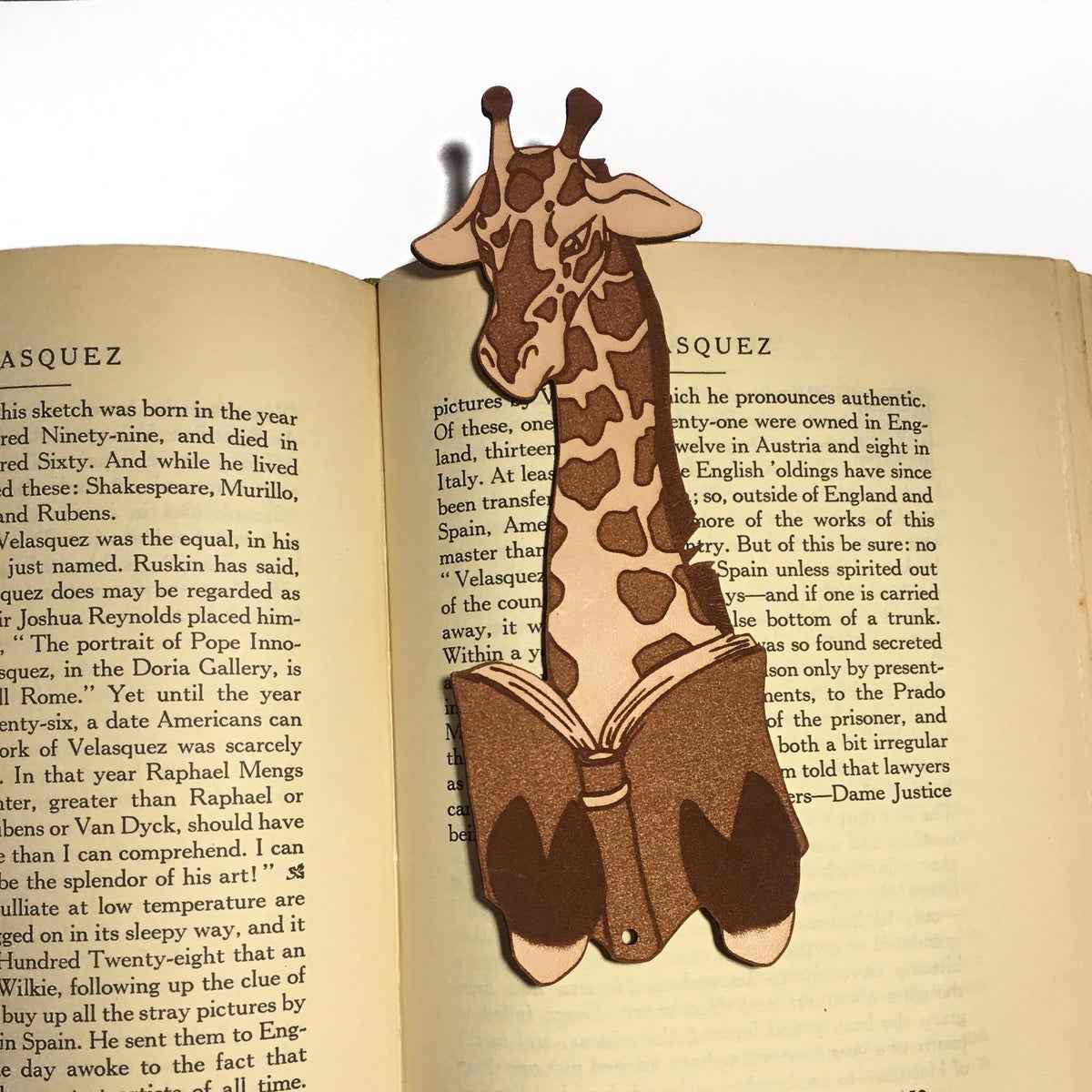 A leather bookmark shaped like a giraffee reading a book. Great Book lover gift. Giraffe Reading Leather Bookmark - Quirky Book-Lover Gift Bookmarks Raven King Crafts
