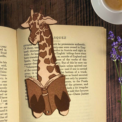 A leather bookmark shaped like a giraffee reading a book. Great Book lover gift. Giraffe Reading Leather Bookmark - Quirky Book-Lover Gift Bookmarks Raven King Crafts
