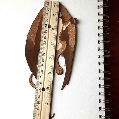 The Griffyn bookmark next to a ruler for scale. Griffin Bookmark - Leather | Wonderful Fantasy Beast Gift Bookmarks Raven King Crafts