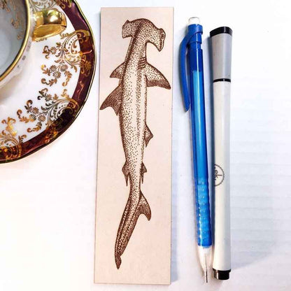 A leather bookmark engraved with the art of a hammerhead shark. Hammerhead Shark Bookmark Bookmarks Raven King Crafts