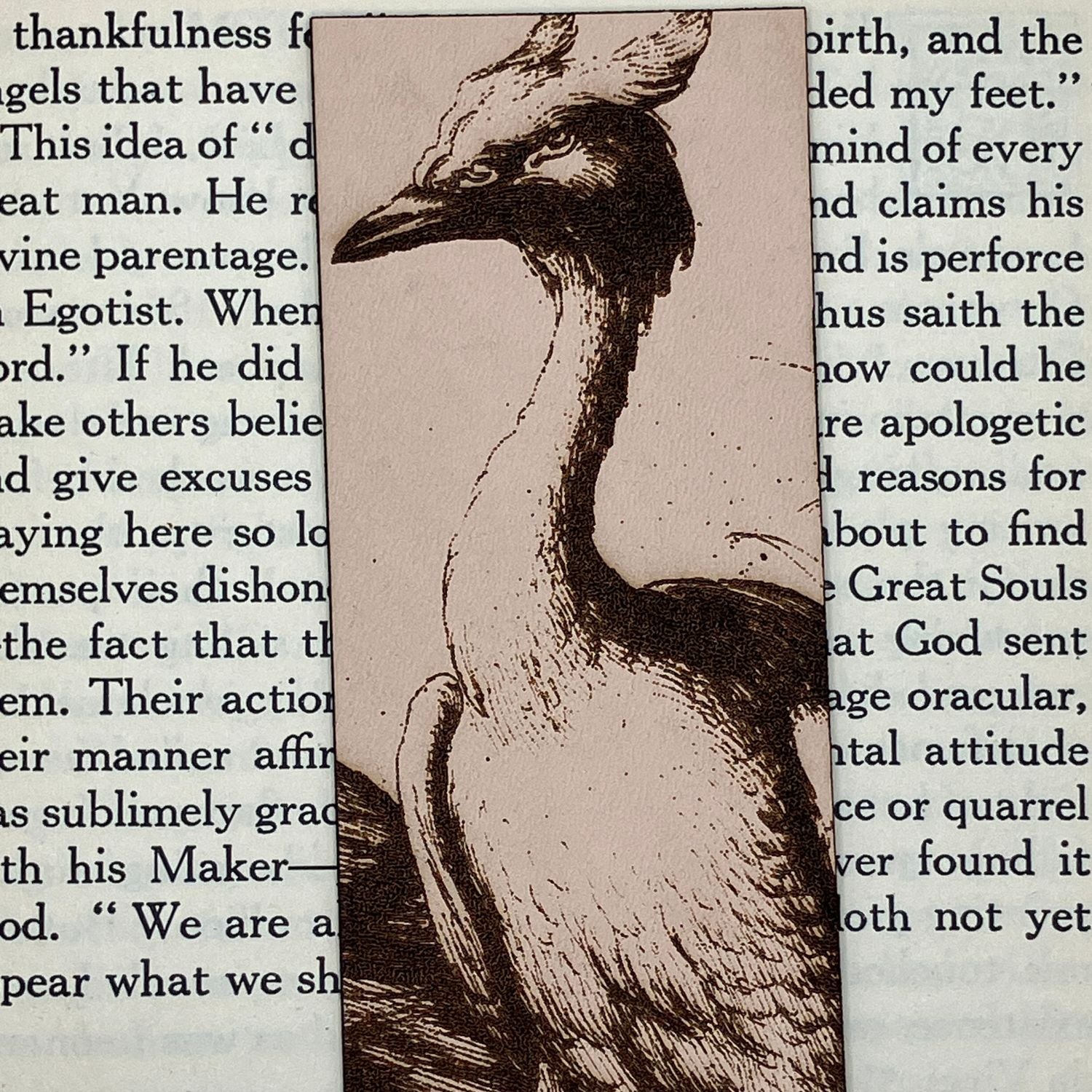 A zoomed in photo of the heron bookmark. The heron illustration is engraved onto leather.