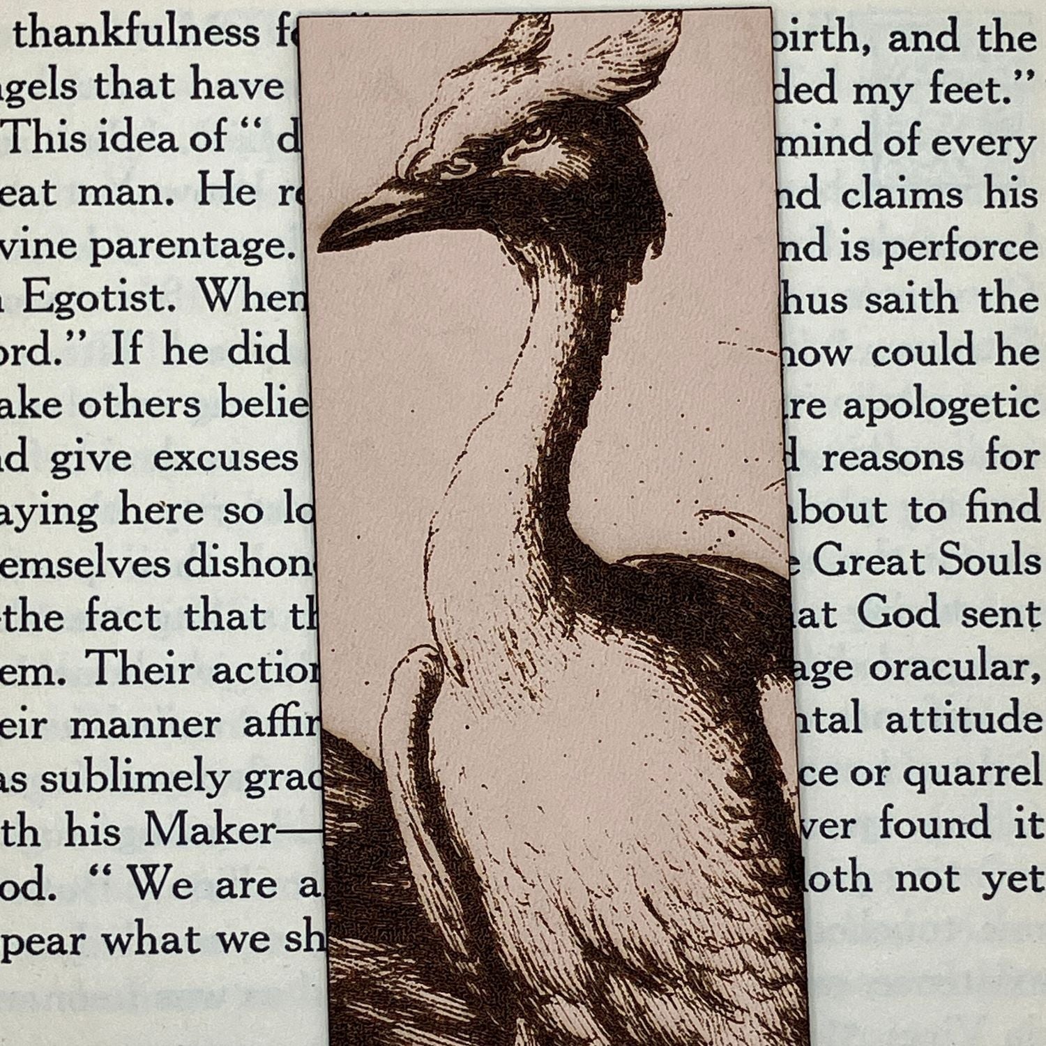A zoomed in photo of the heron bookmark. The heron illustration is engraved onto leather. Heron Bookmark Bookmarks Raven King Crafts