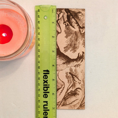 The historical bird bookmark next to a ruler for scale. Historical Birds Bookmark - Leather Bookmarks Raven King Crafts