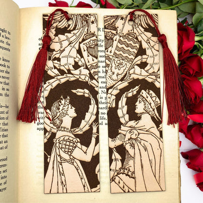 A set of historical bookmarks, a woman in a fine dress is on the left and the right one is a man with a cape and hat. This couple bookmark set has tassels and you can pick the colors, the photo here shows the wine red option. Historical Couple Bookmark Set - Leather Bookmarks Raven King Crafts