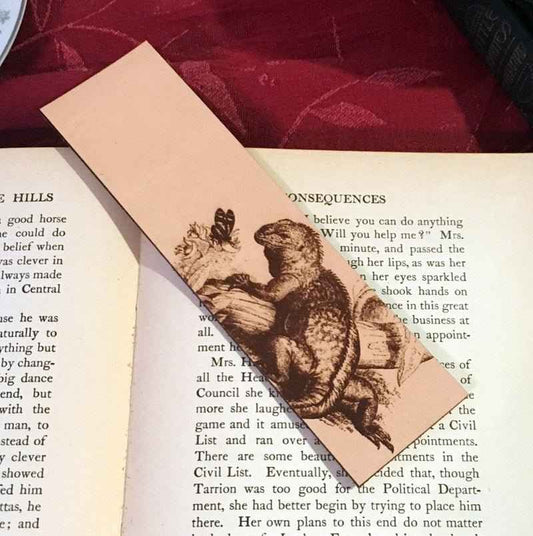 A leather bookmark engraved with the antique art of a iquana. Historical Leather Iguana Bookmark Bookmarks Raven King Crafts