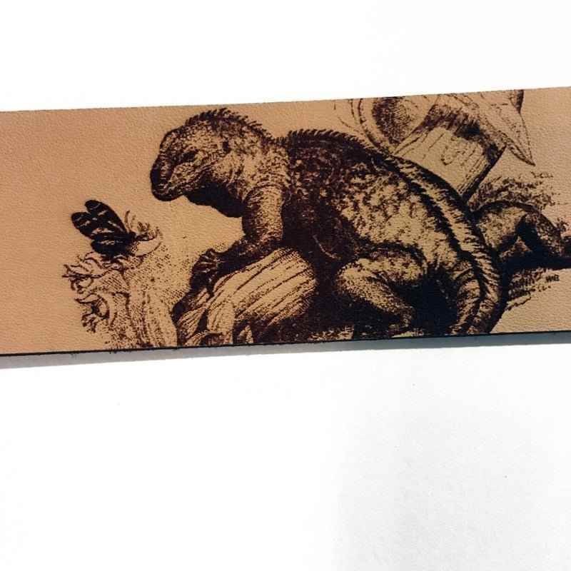 A leather bookmark engraved with the antique art of a iquana. Historical Leather Iguana Bookmark Bookmarks Raven King Crafts
