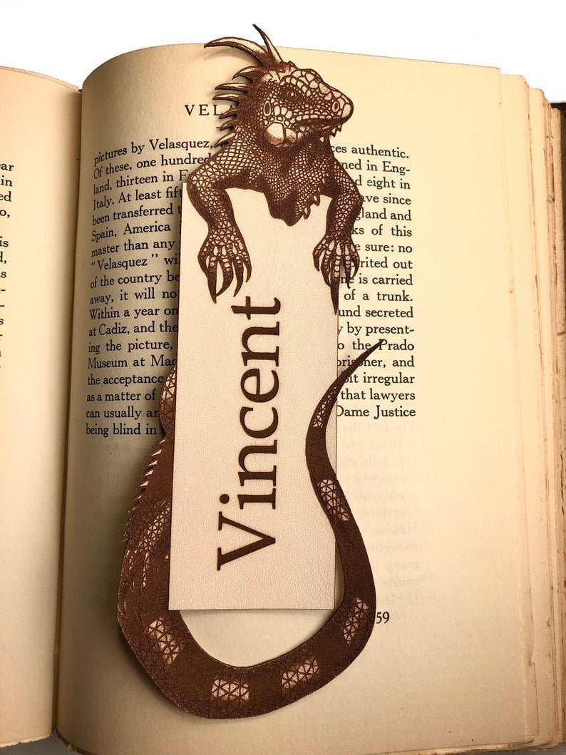 This unique leather bookmark has an iguana hugging a traditional rectangular shaped box.