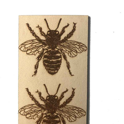 A leather bookmark with the antique art of bees engraved on it. Leather Bee Bookmark Bookmarks Raven King Crafts