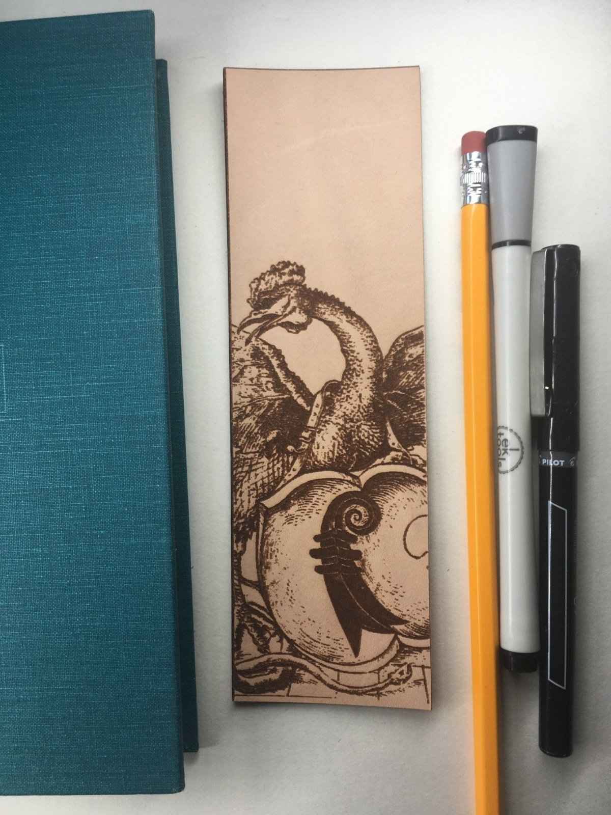Leather bookmark with the antique art of a cockatrice monster engraved on it. Leather Cockatrice Monster Bookmark - Real Leather Bookmarks Raven King Crafts