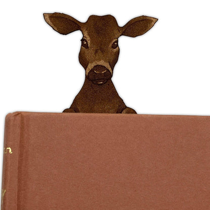 Leather calf bookmark poking out of a book. Leather Cow & Calf Bookmark - Personalize Option Bookmarks Raven King Crafts