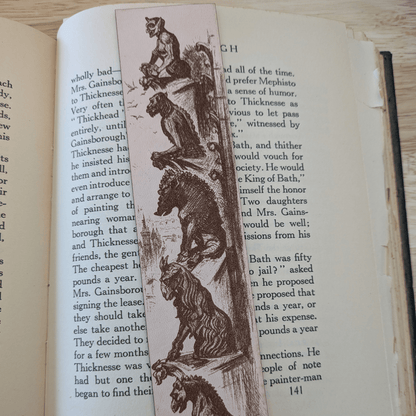 A leather bookmark engraved with the historical art of a collection of gargoyles. Leather Engraved Gargoyles Bookmark