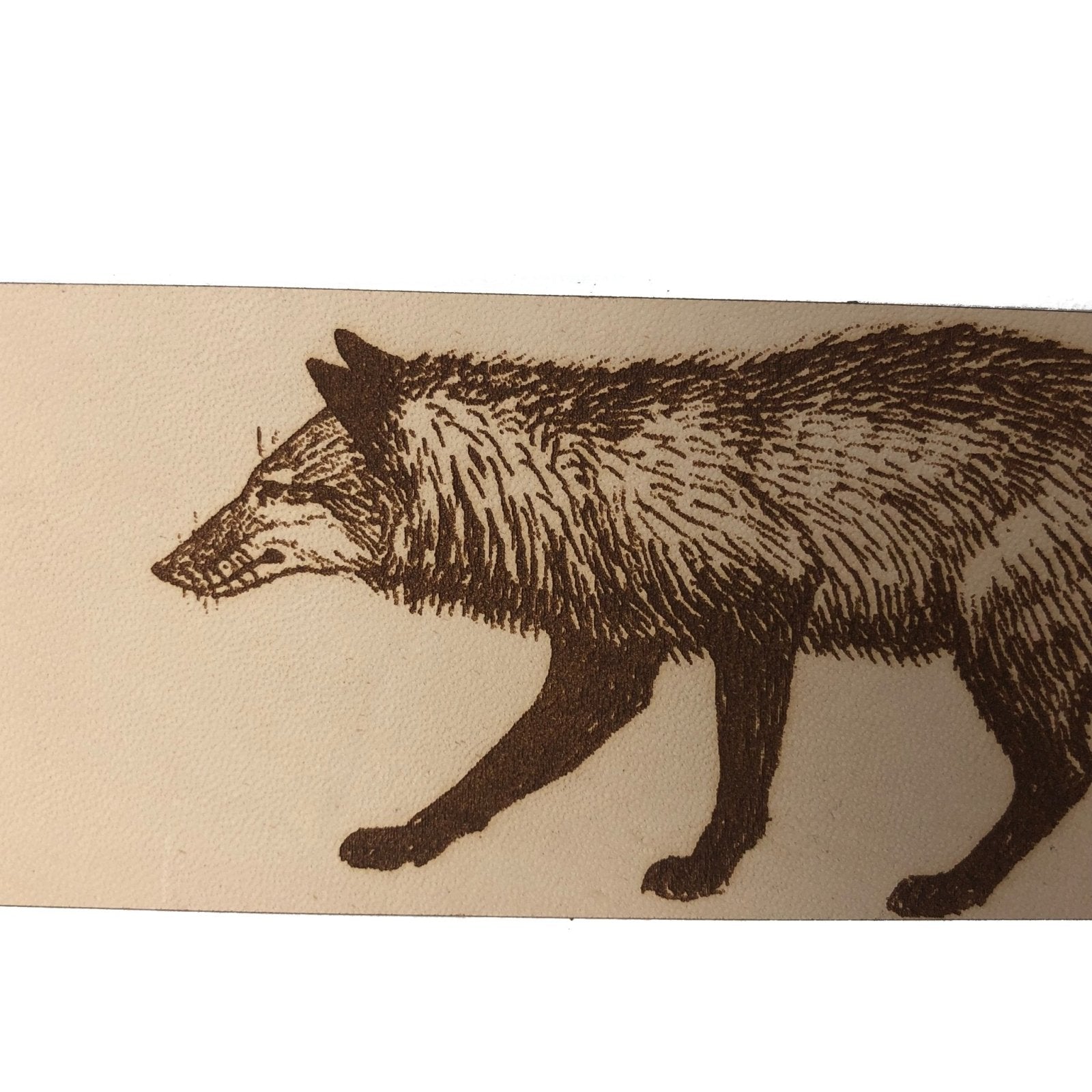 A close up of the red fox face on the leather bookmark.