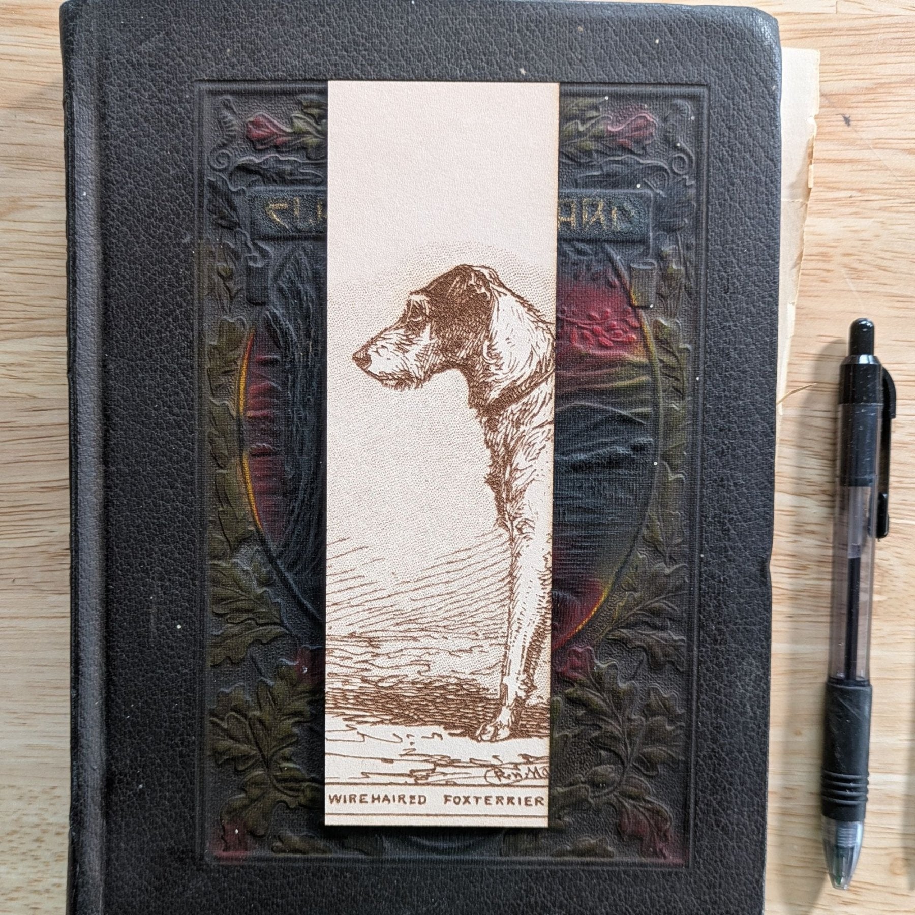 A rectangular leather bookmark with the historical art of a wire haired fox terrier dog engraved on it. Leather Fox Terrier Dog Bookmarks Bookmarks Raven King Crafts Leather Fox Terrier Dog Bookmarks Bookmarks Raven King Crafts