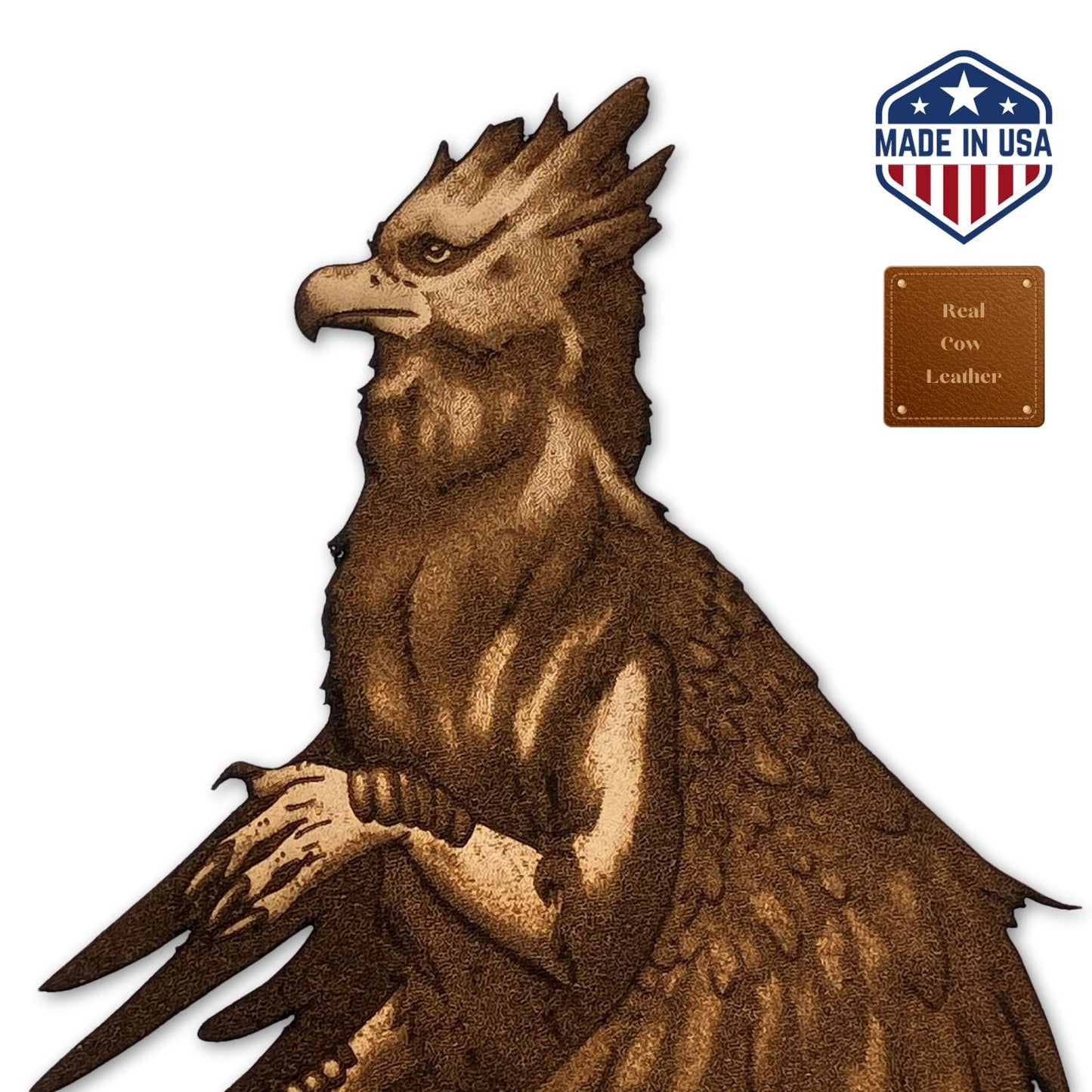 A closeup of the leather hippogriff bookmark head. Next to it you can see a little badge that says made in the usa and a little badge that says real cow leather. Leather Hippogriff Bookmark Bookmarks Raven King Crafts