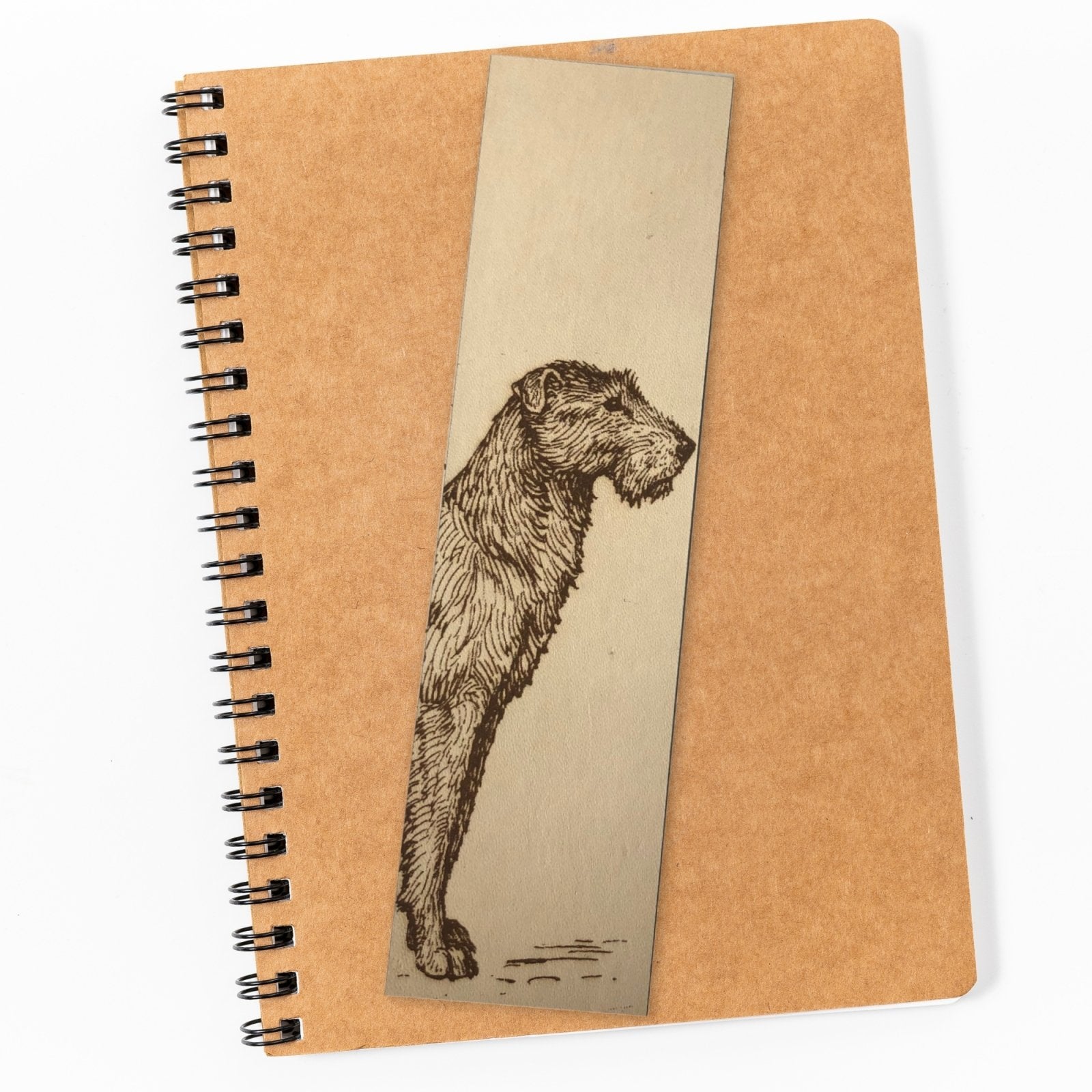 Photograph of a wolfhound bookmark resting on top of a closed notepad.