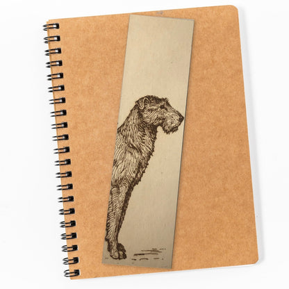 Photograph of a wolfhound bookmark resting on top of a closed notepad.