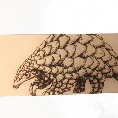 A close up of the pangolin bookmark.