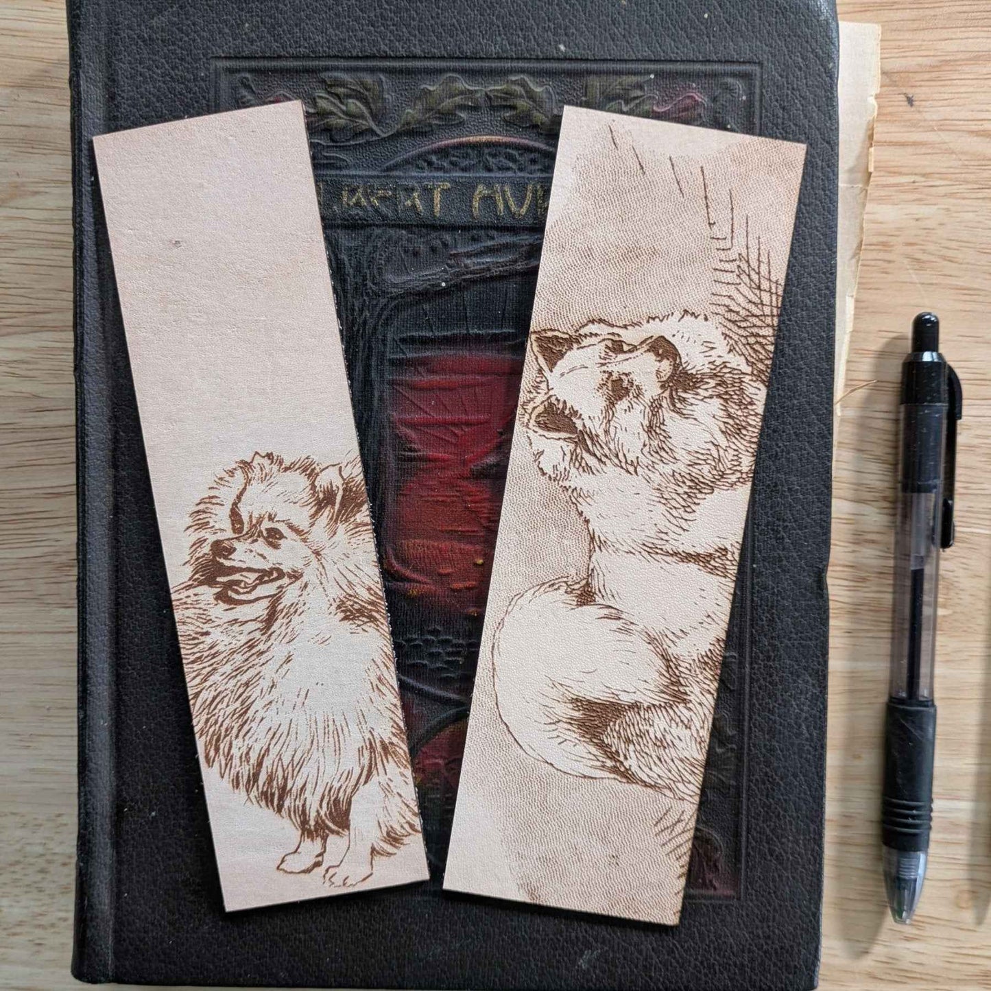 These leather bookmarks are engraved with the art of a pomeranian dog on it. Leather Pomeranian Bookmark Bookmarks Raven King Crafts