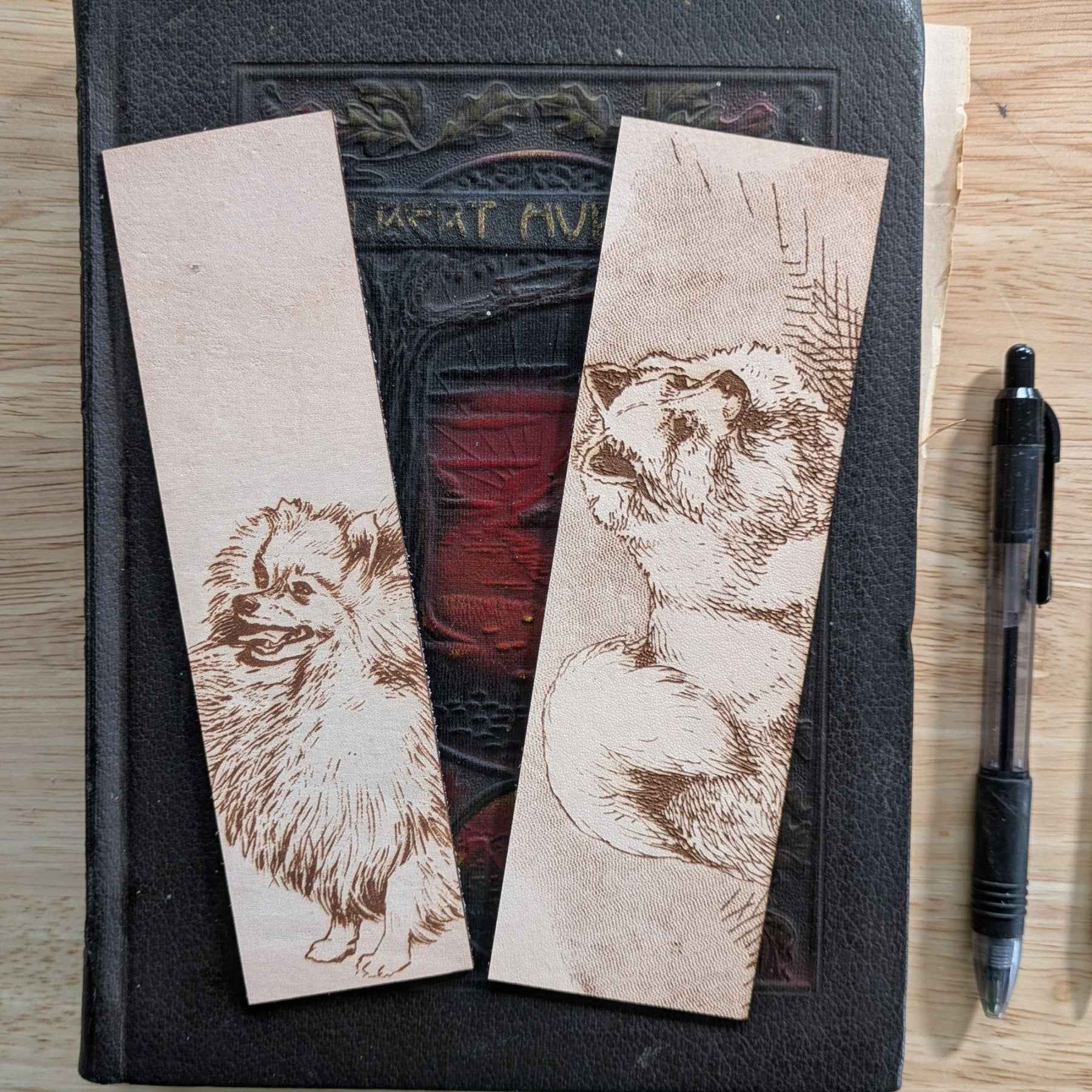 These leather bookmarks are engraved with the art of a pomeranian dog on it. Leather Pomeranian Bookmark Bookmarks Raven King Crafts