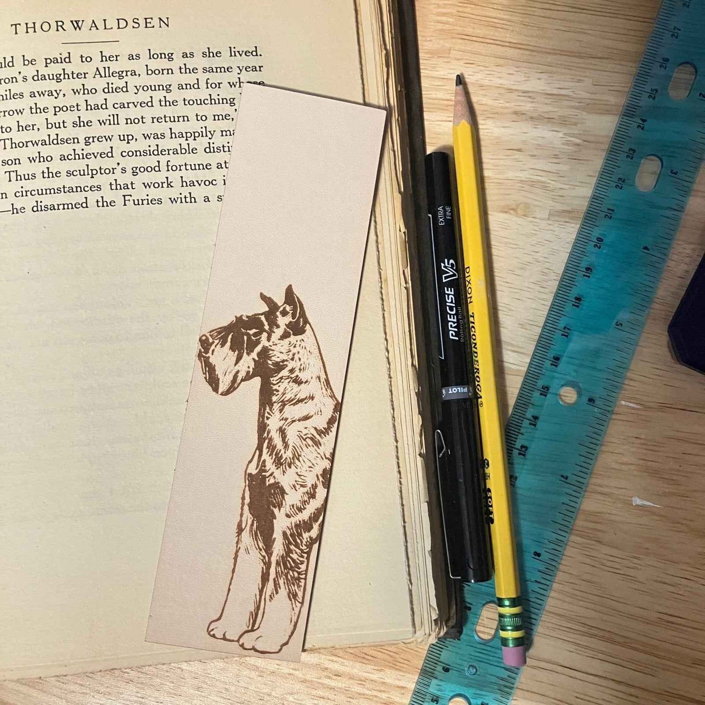 This leather bookmark is engraved with the art of a Schnauzer dog on it. Leather Schnauzer Bookmark Bookmarks Raven King Crafts