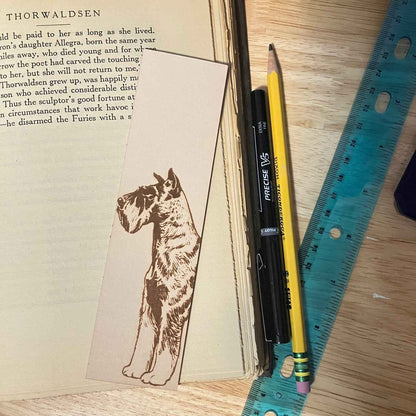 This leather bookmark is engraved with the art of a Schnauzer dog on it. Leather Schnauzer Bookmark Bookmarks Raven King Crafts