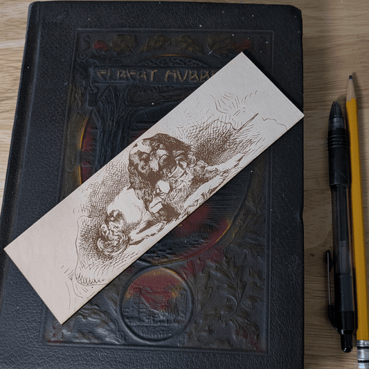A rectangular leather bookmark with the historical art of a small spaniel dog engraved on it. Leather Spaniel Bookmark Bookmarks Raven King Crafts Leather Spaniel Bookmark Bookmarks Raven King Crafts