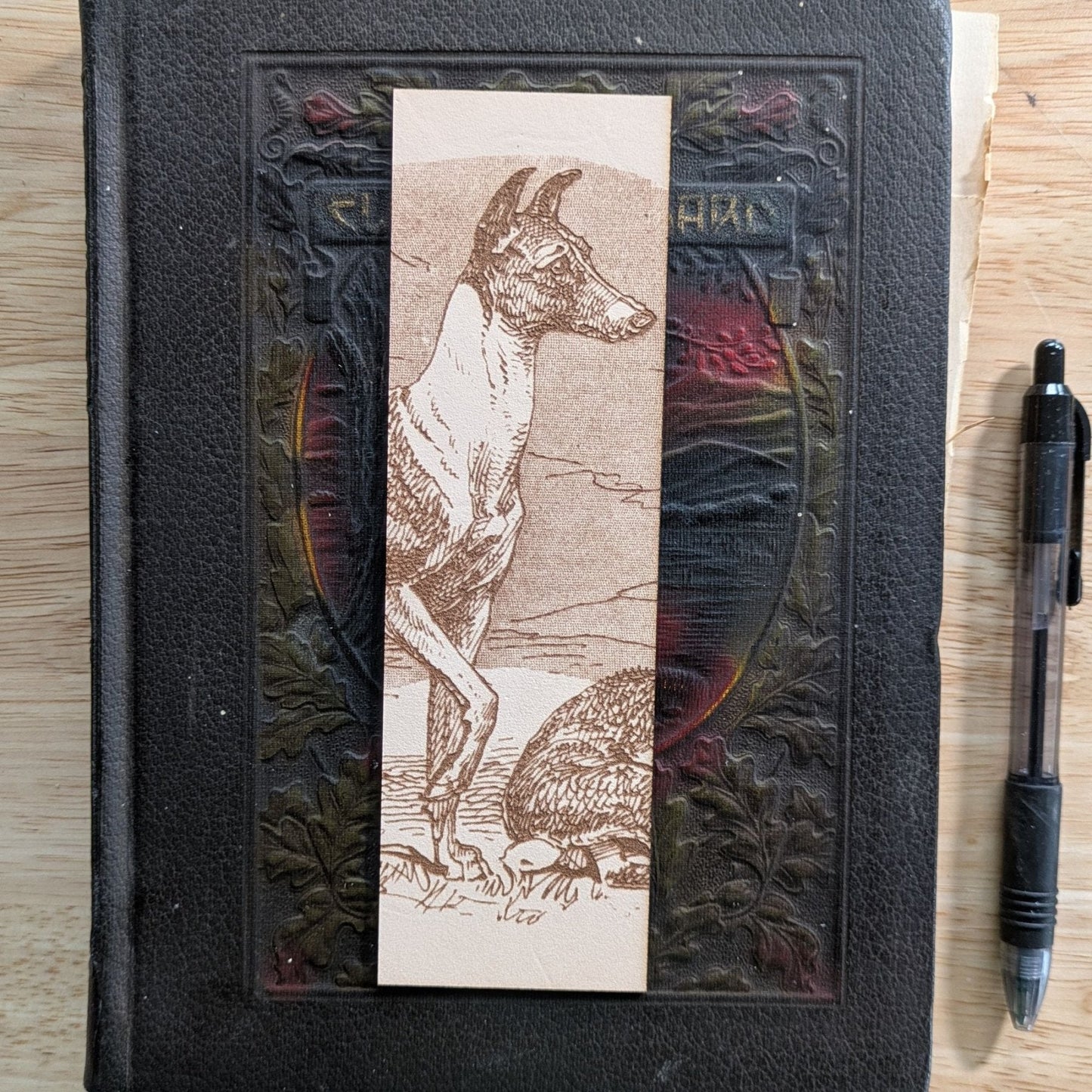 A rectangular leather bookmark with the historical art of a Whippet dog engraved on it. Leather Whippet Dog Bookmark Bookmarks Raven King Crafts Leather Whippet Dog Bookmark Bookmarks Raven King Crafts