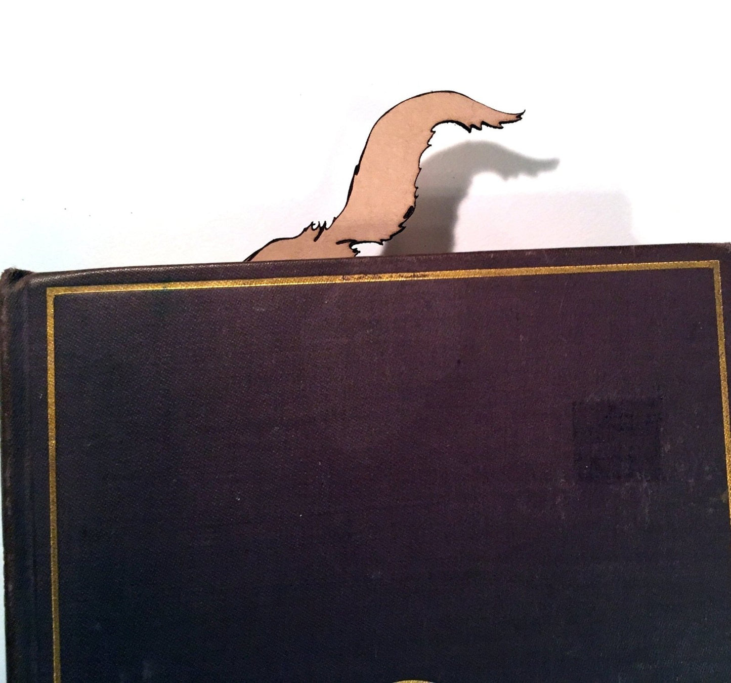 The wolf bookmark's tail sticking out of the book.