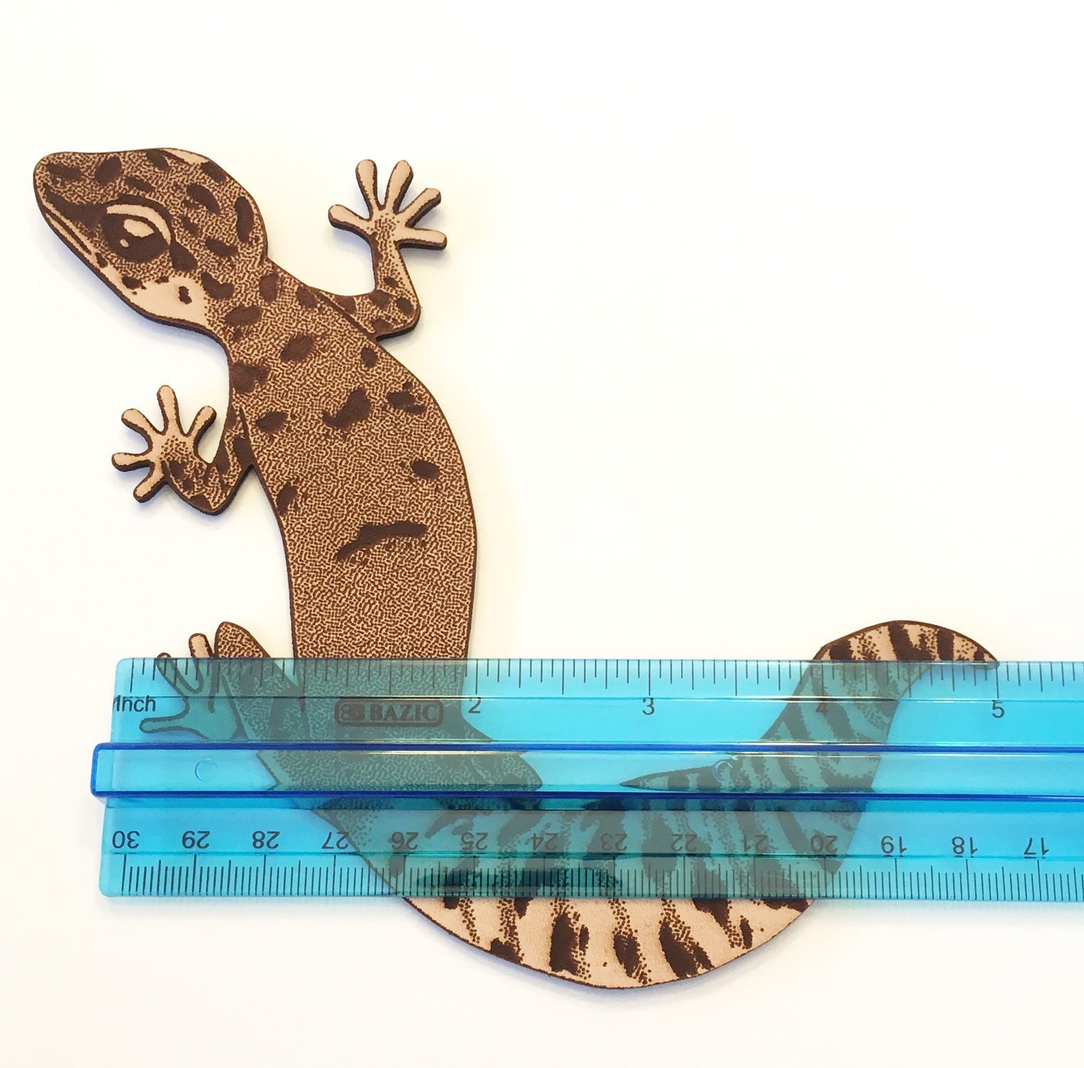 The gecko bookmark by a ruler for scale.