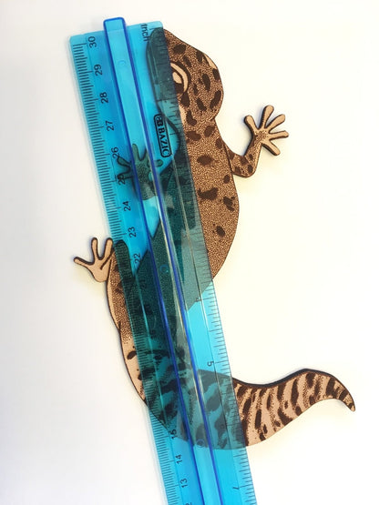 The gecko bookmark by a ruler for scale.