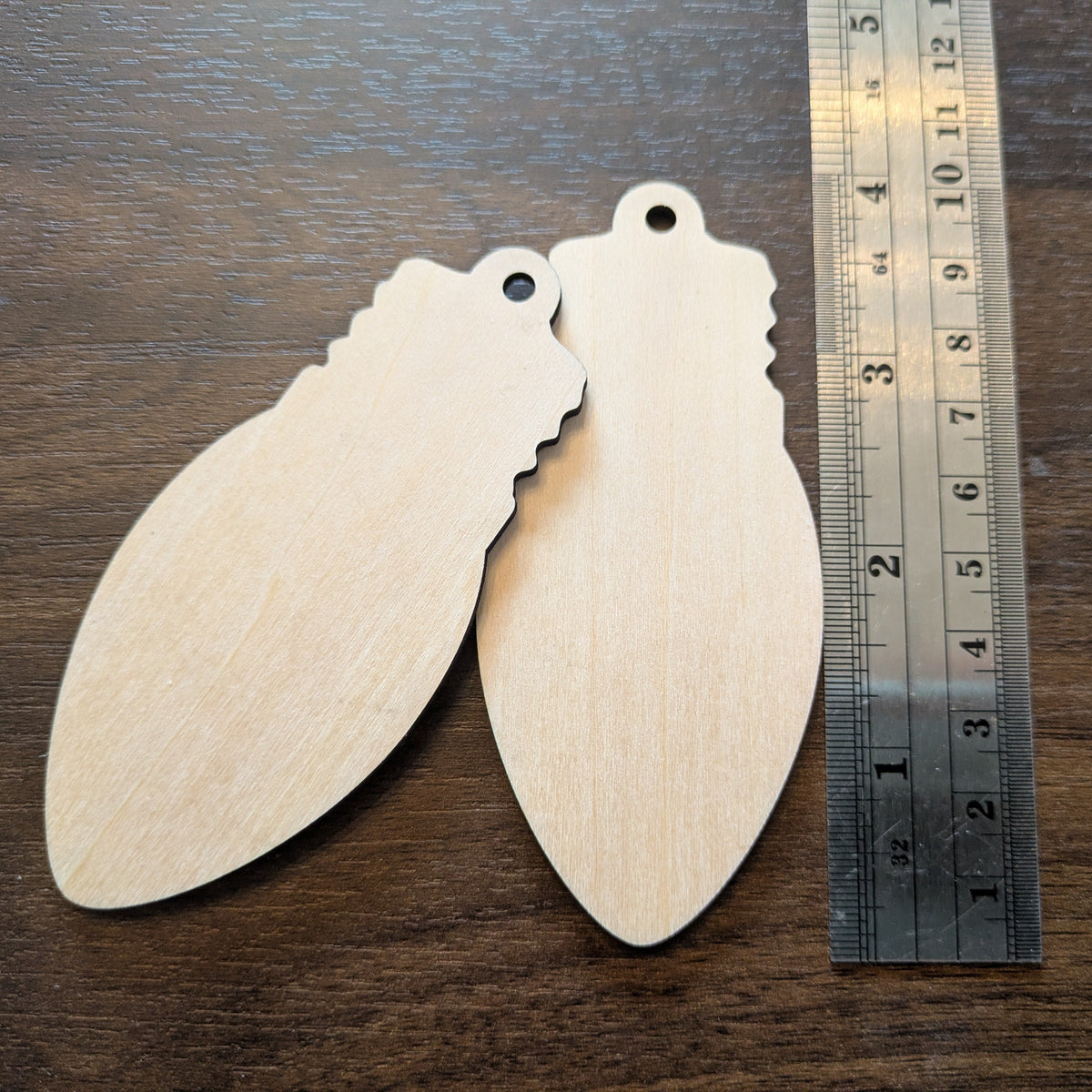 The wooden Lightbulb ornament blanks next to a ruler for scale. 
