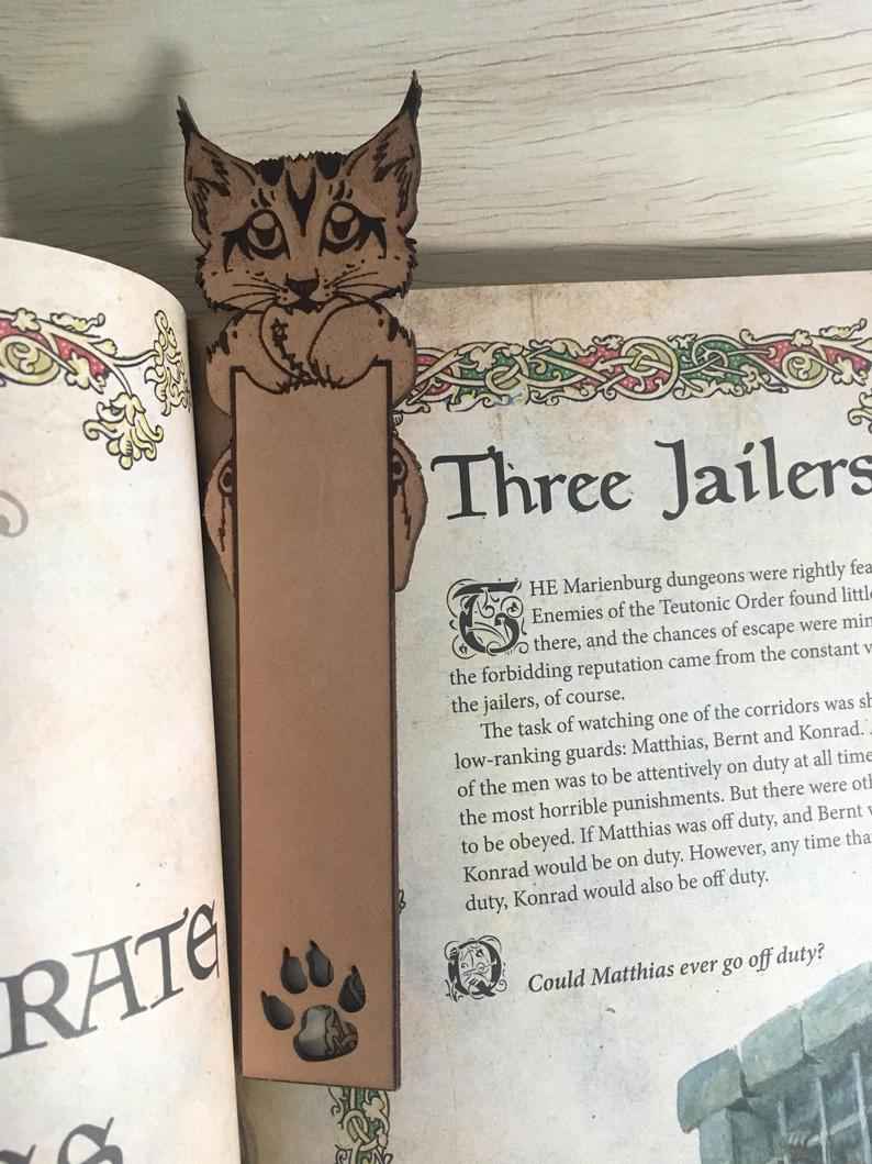 This leather lynx cub bookmark can be engraved with a short message or name. Lynx Cub Bookmark Bookmarks Raven King Crafts