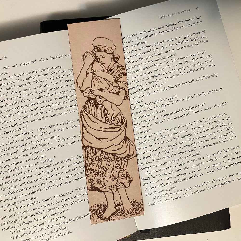 A leather bookmark engraved with the antique art of a mother and child. Mother and Child Leather Bookmark Bookmarks Raven King Crafts