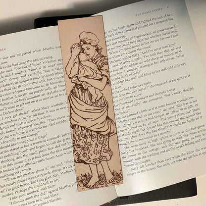 A leather bookmark engraved with the antique art of a mother and child. Mother and Child Leather Bookmark Bookmarks Raven King Crafts