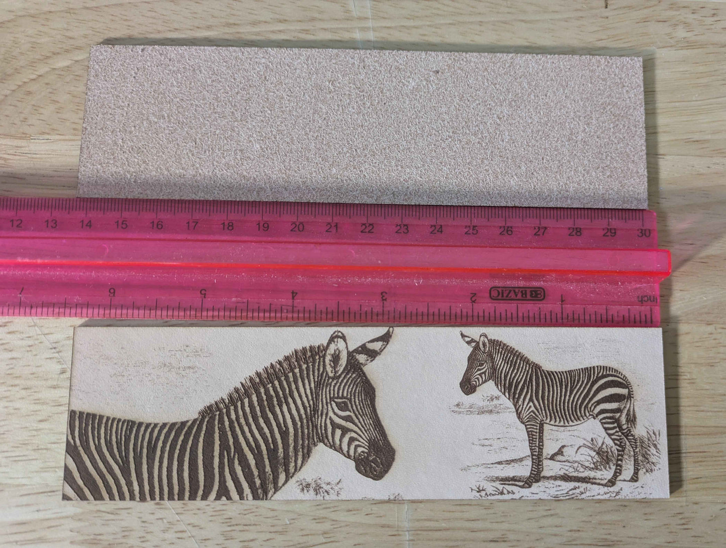 The leather zebra bookmark next to a ruler for scale. Mountain Zebra - Leather Bookmark Bookmarks Raven King Crafts
