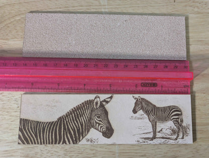 The leather zebra bookmark next to a ruler for scale. Mountain Zebra - Leather Bookmark Bookmarks Raven King Crafts