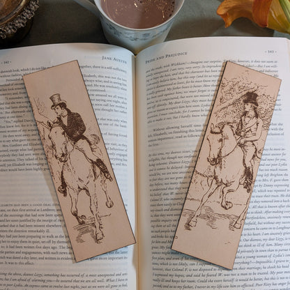 Mr. Darcy and Mr. Bingley on horseback leather bookmarks. Resting on the pages of an open book. Mr. Darcy and Mr. Bingley on horseback bookmarks Bookmarks Raven King Crafts