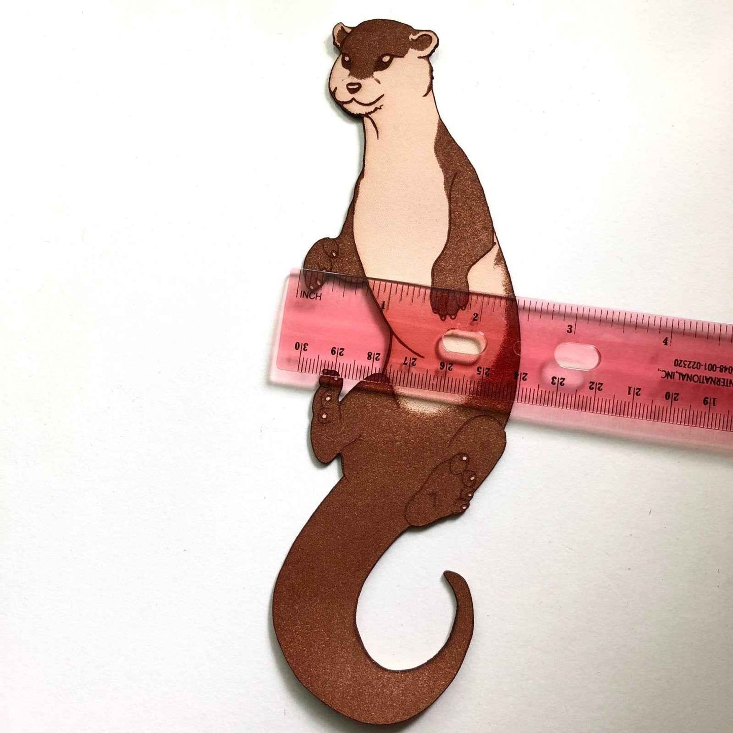 A cute otter bookmark next to a ruler for scale. Otter Bookmark Bookmarks Raven King Crafts