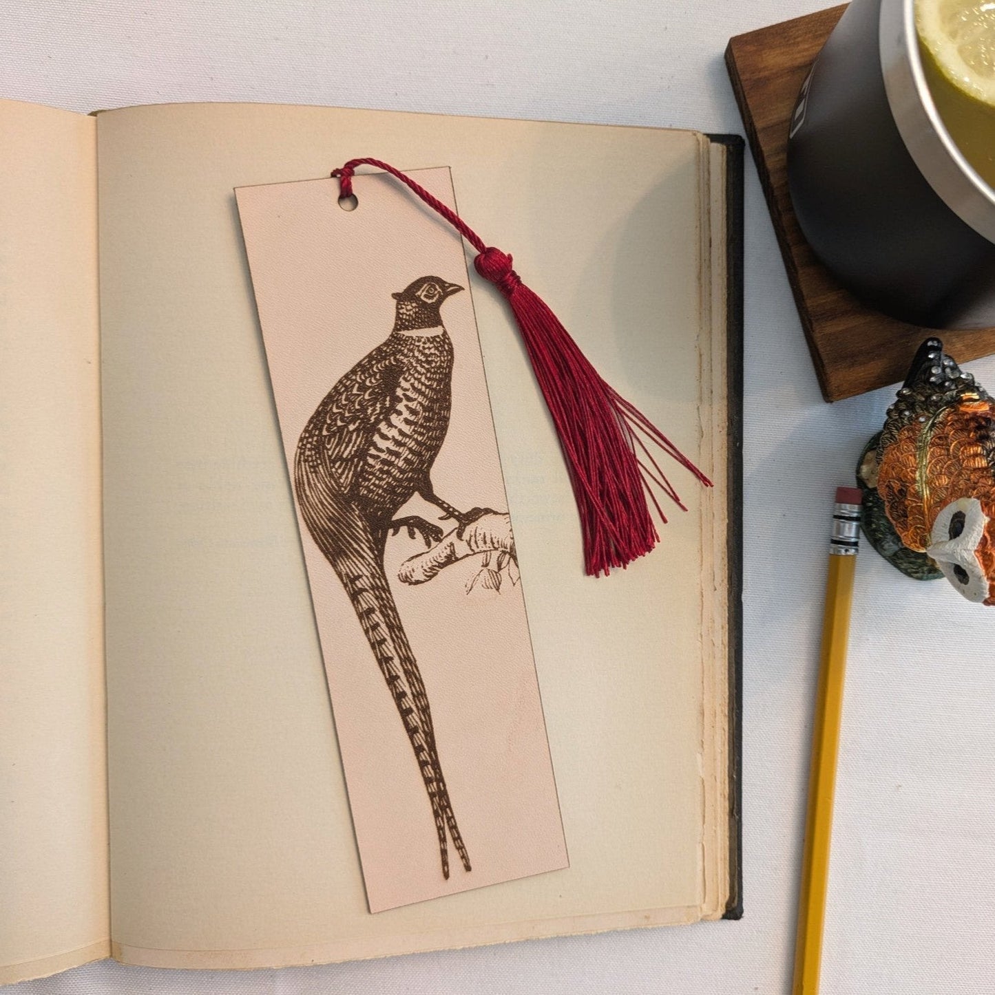 A leather bookmark with the antique art of a pheasant bird engraved on it. Pheasant Bird Bookmark - Leather Bookmarks Raven King Crafts
