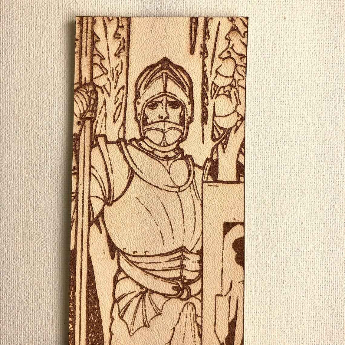 A leather bookmark with the antique art of a knight wearing plate armor engraved on it. Plate Armored Knight Leather Bookmark Bookmarks Raven King Crafts
