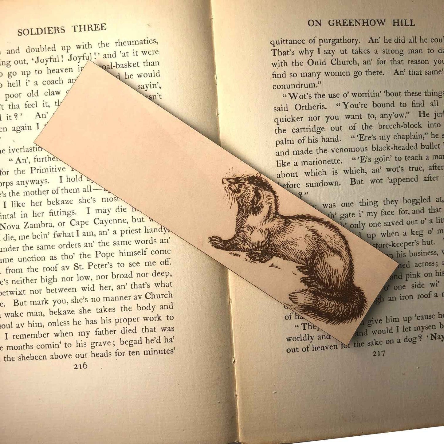 Leather bookmark engraved with the historical art of a weasel on it.