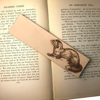 Leather bookmark engraved with the historical art of a weasel on it.