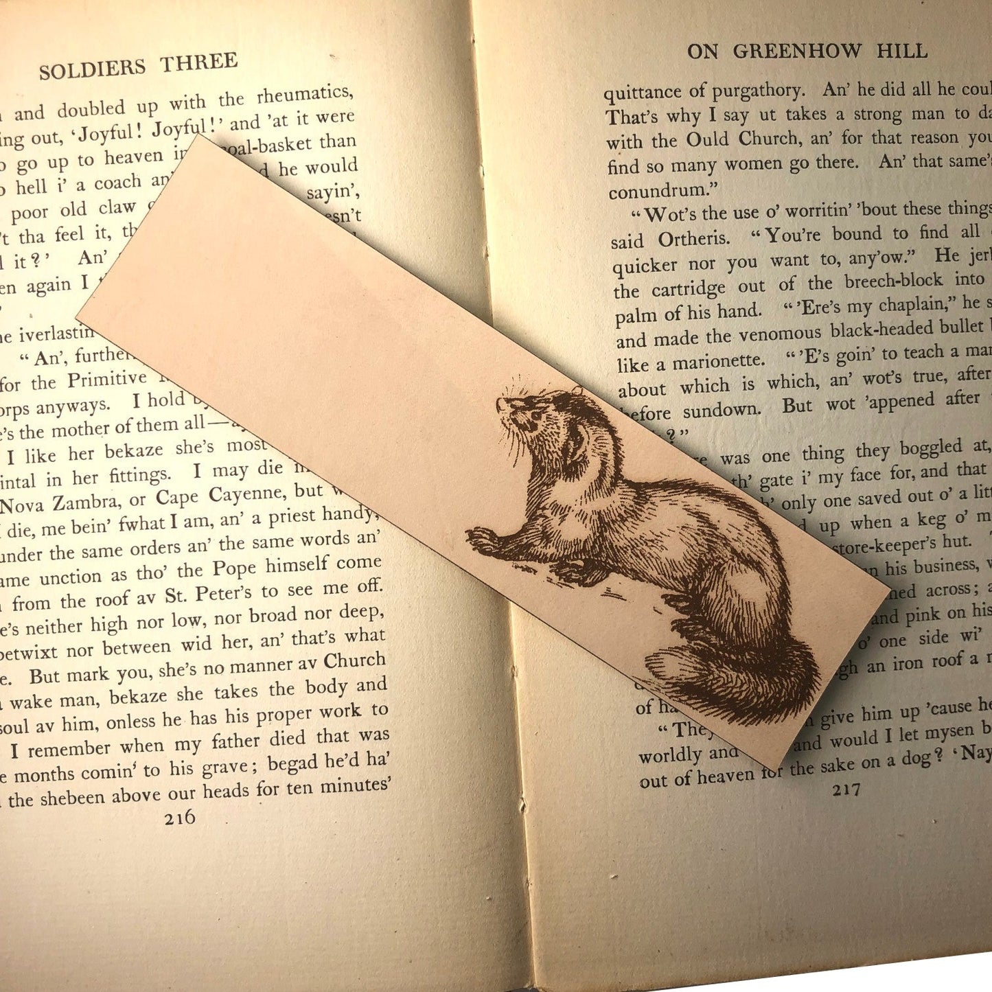 A rectangular leather bookmark with the art of a polecat engraved on it.