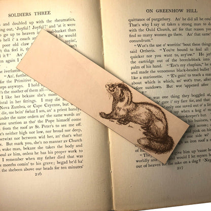 A rectangular leather bookmark with the art of a polecat engraved on it.