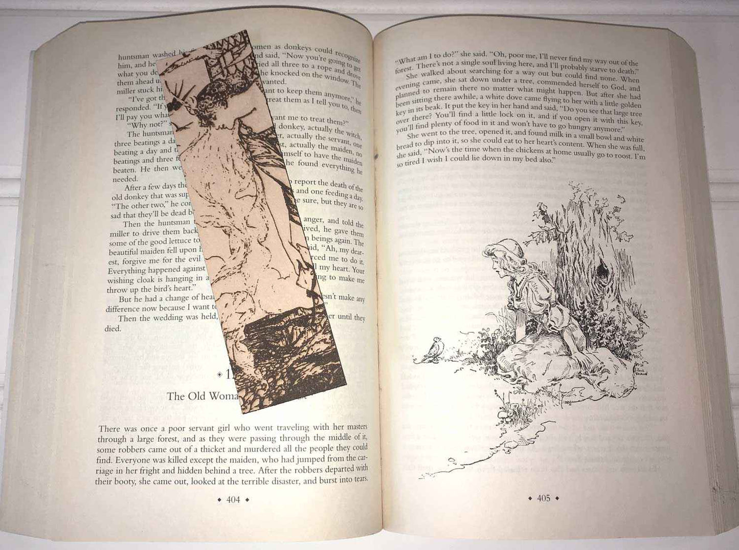 A leather bookmark with the antique art of a Princess Leaning Out The Tower on it. Princess Leaning Out The Tower Bookmark Bookmarks Raven King Crafts