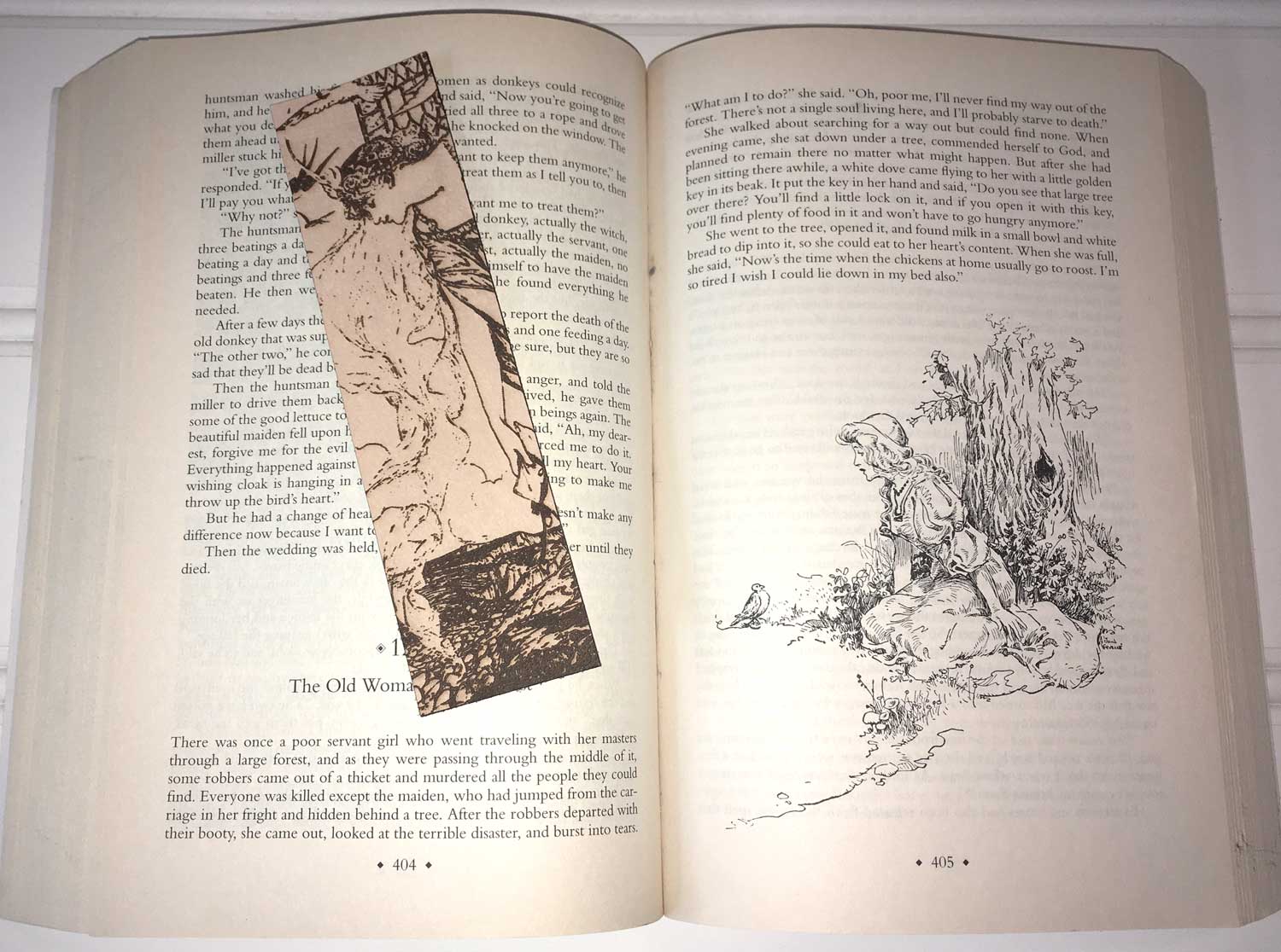 The princess in a tower bookmark resting on the pages of an old fable book.